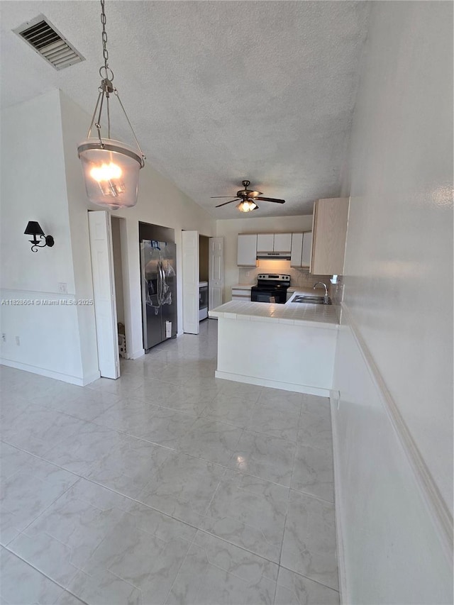 13567 SW 286th Ter, Homestead, FL 33033 - kitchen featuring stainless steel refrigerator with ice dispenser, electric range oven, light marble finish floors, ceiling fan, and lofted ceiling