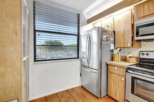 1532 Whitehall Dr Unit 202, Davie, FL 33324 - kitchen with appliances with stainless steel finishes, decorative backsplash, light countertops, and light wood-type flooring