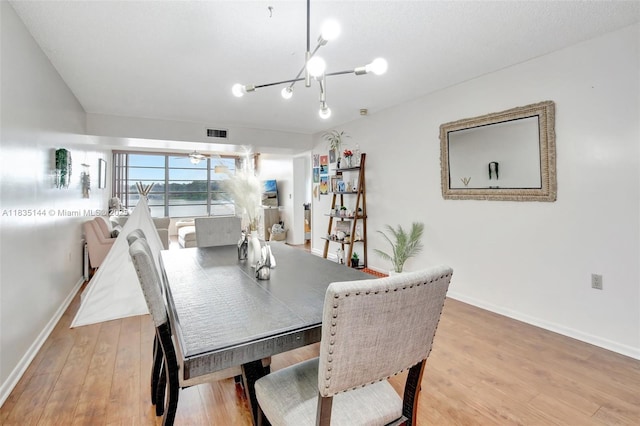 1532 Whitehall Dr Unit 202, Davie, FL 33324 - dining area featuring a chandelier and light wood finished floors