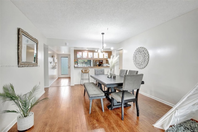 1532 Whitehall Dr Unit 202, Davie, FL 33324 - dining area with hardwood / wood-style flooring, a textured ceiling, and a chandelier