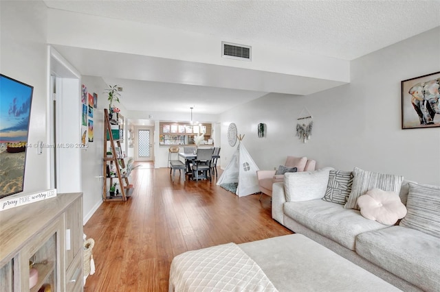 1532 Whitehall Dr Unit 202, Davie, FL 33324 - living room featuring light wood-style flooring and a textured ceiling