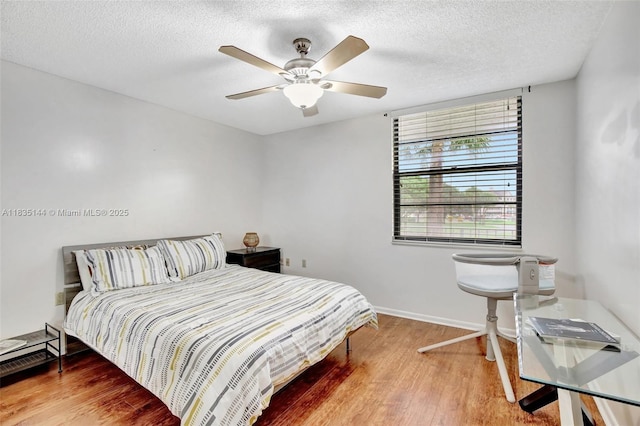 1532 Whitehall Dr Unit 202, Davie, FL 33324 - bedroom with wood finished floors, a textured ceiling, and a ceiling fan