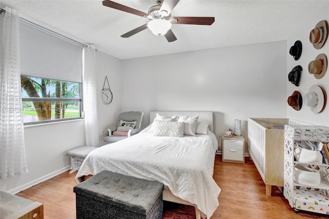 1532 Whitehall Dr Unit 202, Davie, FL 33324 - bedroom with light wood-style floors, a ceiling fan, and a textured ceiling