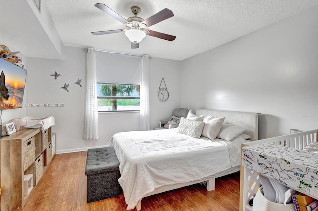 1532 Whitehall Dr Unit 202, Davie, FL 33324 - bedroom with light wood finished floors, a textured ceiling, and a ceiling fan