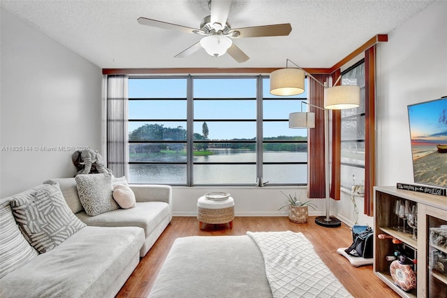 1532 Whitehall Dr Unit 202, Davie, FL 33324 - living area with a ceiling fan, a textured ceiling, and wood finished floors