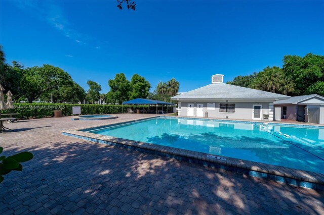 1532 Whitehall Dr Unit 202, Davie, FL 33324 - community pool featuring a community hot tub, a patio, and view of wooded area
