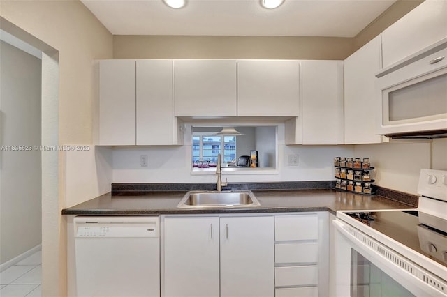 4805 NW 35th St Unit 603, Lauderdale Lakes, FL 33319 - kitchen featuring white appliances, white cabinetry, dark countertops, and recessed lighting