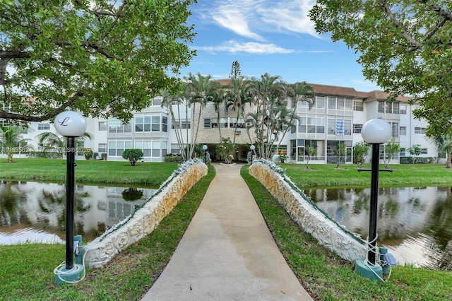 4805 NW 35th St Unit 603, Lauderdale Lakes, FL 33319 - view of property's community with a water view and a lawn