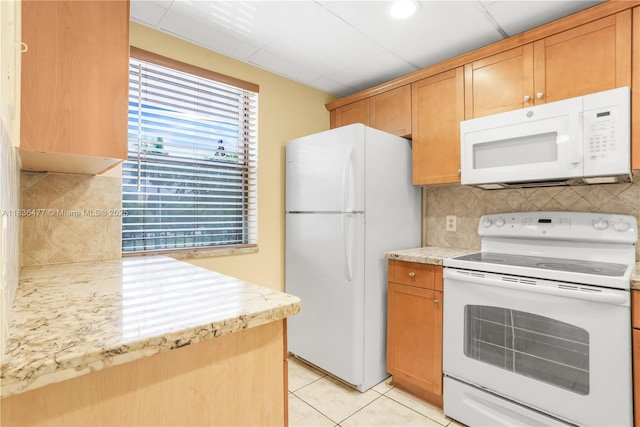 10332 Sunrise Lakes Blvd Unit 206, Sunrise, FL 33322 - kitchen featuring white appliances, light tile patterned floors, decorative backsplash, and light stone countertops