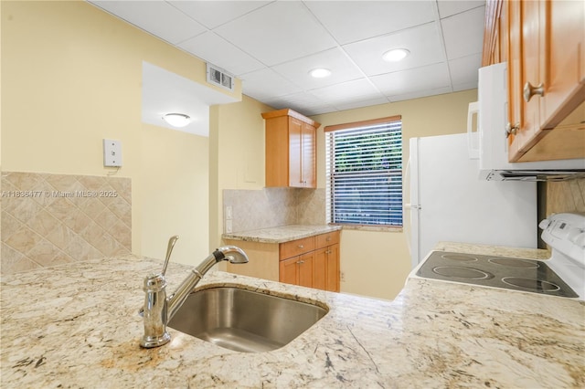 10332 Sunrise Lakes Blvd Unit 206, Sunrise, FL 33322 - kitchen featuring range with electric cooktop, tasteful backsplash, light stone countertops, white microwave, and a paneled ceiling