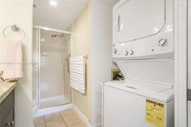 10332 Sunrise Lakes Blvd Unit 206, Sunrise, FL 33322 - laundry area with stacked washer / drying machine and light tile patterned flooring