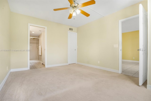 10332 Sunrise Lakes Blvd Unit 206, Sunrise, FL 33322 - unfurnished bedroom featuring light colored carpet, light tile patterned floors, ensuite bath, and a ceiling fan