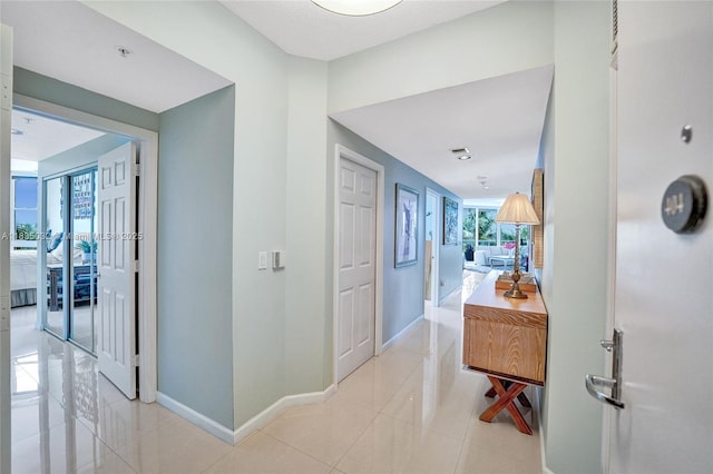 6051 N Ocean Dr Unit 404, Hollywood, FL 33019 - hallway featuring baseboards and light tile patterned floors