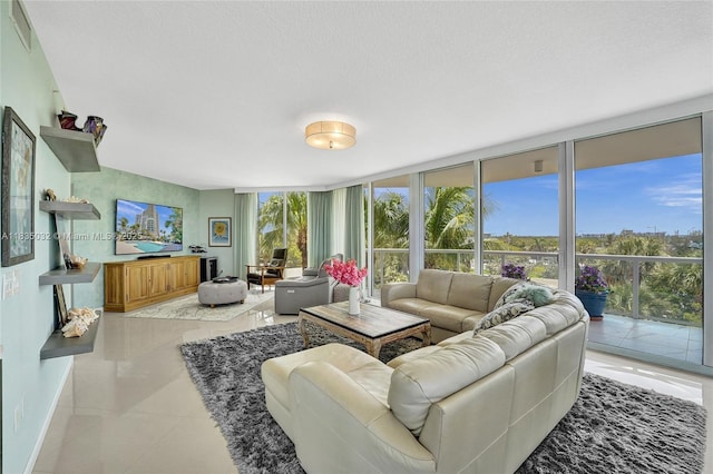 6051 N Ocean Dr Unit 404, Hollywood, FL 33019 - living area with floor to ceiling windows, tile patterned floors, and a textured ceiling