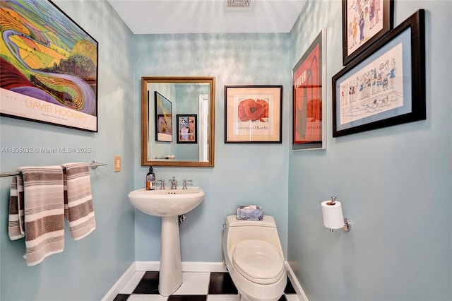 6051 N Ocean Dr Unit 404, Hollywood, FL 33019 - half bathroom featuring toilet and baseboards