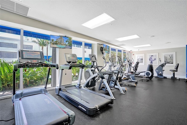 6051 N Ocean Dr Unit 404, Hollywood, FL 33019 - exercise room with a textured ceiling