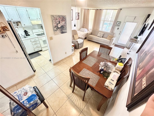 9021 Sunrise Lakes Blvd Unit 104, Sunrise, FL 33322 - dining room featuring light tile patterned floors and a textured ceiling
