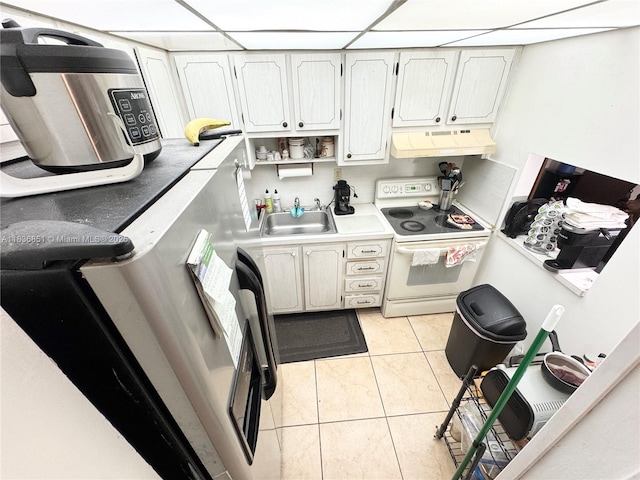9021 Sunrise Lakes Blvd Unit 104, Sunrise, FL 33322 - kitchen with white electric range, under cabinet range hood, fridge, light tile patterned flooring, and light countertops