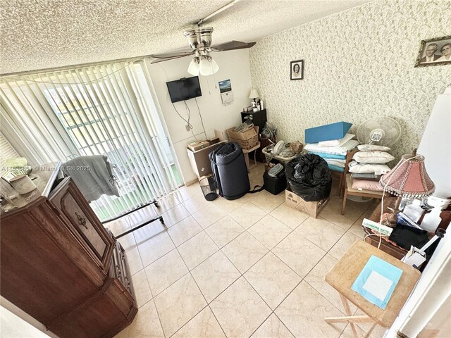 9021 Sunrise Lakes Blvd Unit 104, Sunrise, FL 33322 - living room with ceiling fan, a textured ceiling, tile patterned floors, and wallpapered walls