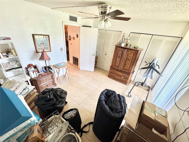 9021 Sunrise Lakes Blvd Unit 104, Sunrise, FL 33322 - interior space with light tile patterned floors, ceiling fan, a textured ceiling, and multiple closets