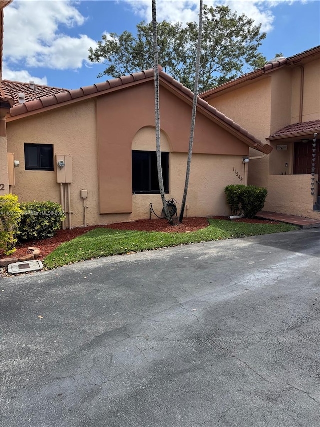 11248 SW 11th St, Pembroke Pines, FL 33025 - view of side of home featuring stucco siding and a tiled roof