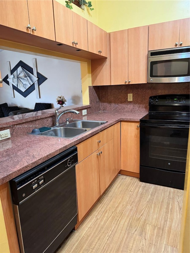 11248 SW 11th St, Pembroke Pines, FL 33025 - kitchen with black appliances, light brown cabinets, light wood-style floors, decorative backsplash, and dark countertops