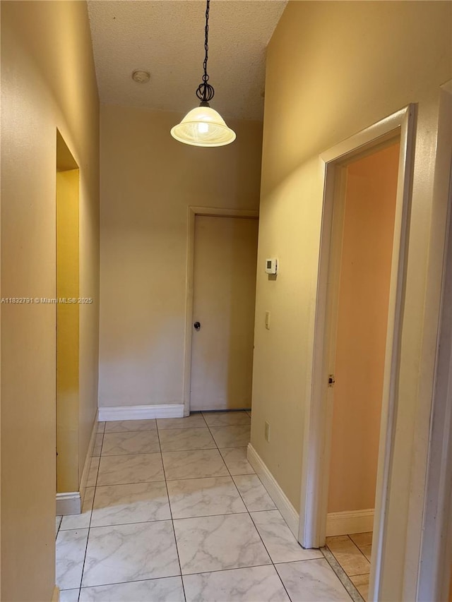 11248 SW 11th St, Pembroke Pines, FL 33025 - corridor featuring light marble finish flooring and a textured ceiling