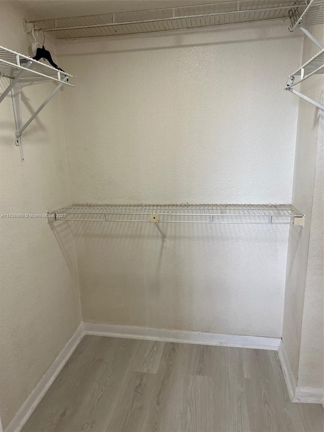 6060 W 21st Ct Unit 205, Hialeah, FL 33016 - walk in closet with wood finished floors