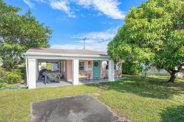 1679 NE 175th St, North Miami Beach, FL 33162 - view of front of property with an attached carport, stucco siding, and covered porch
