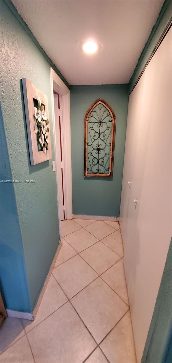 1679 NE 175th St, North Miami Beach, FL 33162 - hall featuring light tile patterned floors