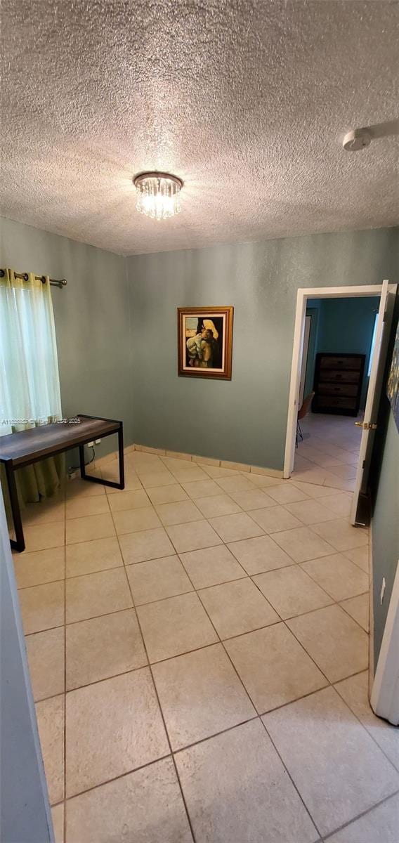 1679 NE 175th St, North Miami Beach, FL 33162 - hallway featuring light tile patterned flooring and a textured ceiling