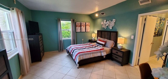 1679 NE 175th St, North Miami Beach, FL 33162 - bedroom with light tile patterned floors and vaulted ceiling