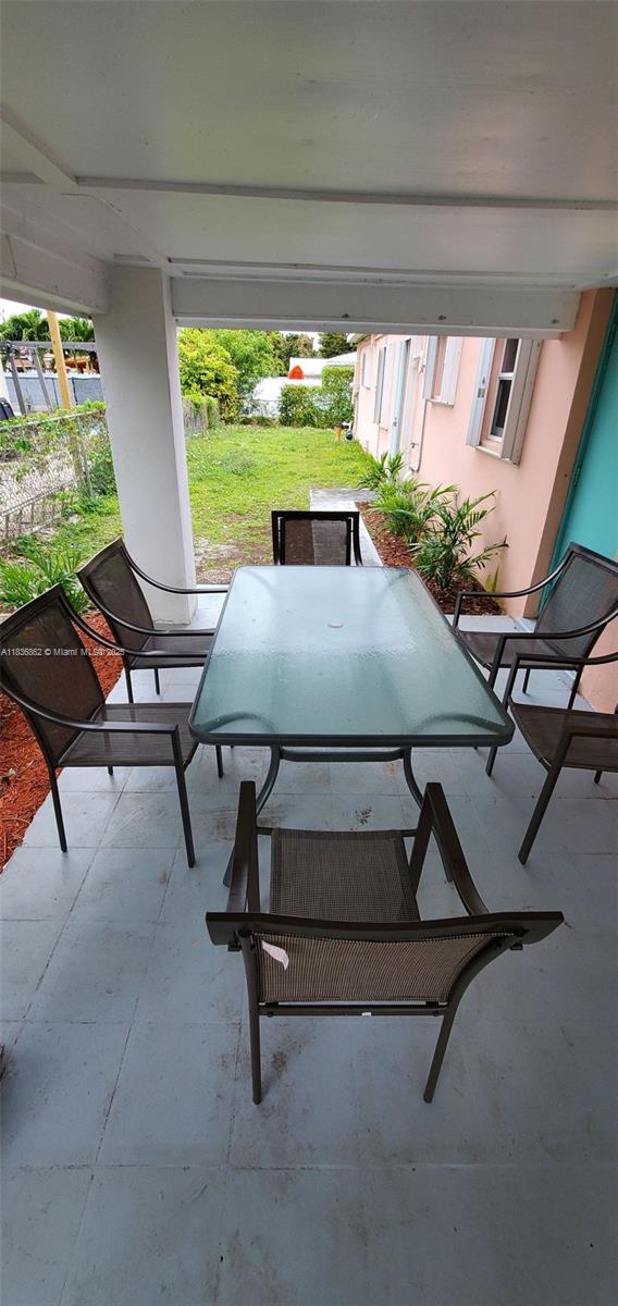 1679 NE 175th St, North Miami Beach, FL 33162 - view of patio / terrace featuring outdoor dining space