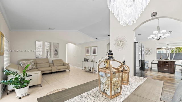 8775 NW 168th St, Miami Lakes, FL 33018 - living room featuring a chandelier, arched walkways, lofted ceiling, crown molding, and light tile patterned floors