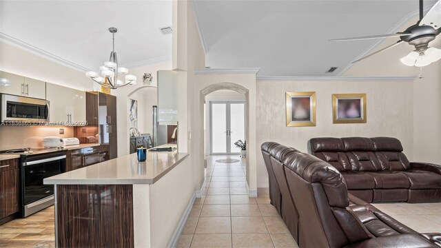 8775 NW 168th St, Miami Lakes, FL 33018 - kitchen with stainless steel appliances, arched walkways, ornamental molding, open floor plan, and light countertops