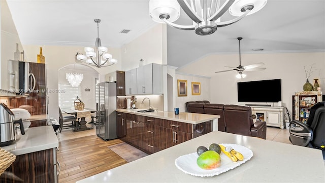 8775 NW 168th St, Miami Lakes, FL 33018 - kitchen featuring a chandelier, appliances with stainless steel finishes, light countertops, ornamental molding, and dark brown cabinets