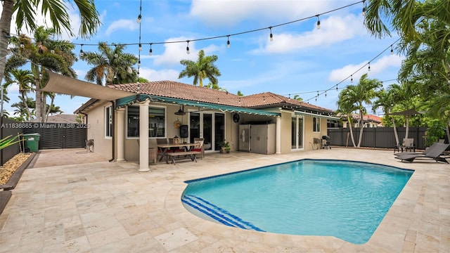8775 NW 168th St, Miami Lakes, FL 33018 - rear view of house featuring a tile roof, stucco siding, a fenced backyard, and a patio area