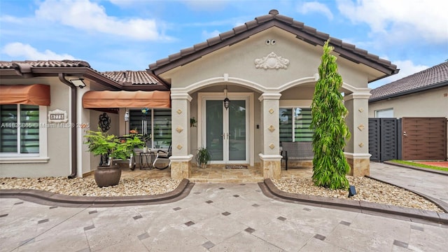 8775 NW 168th St, Miami Lakes, FL 33018 - property entrance featuring french doors, stucco siding, and a tile roof