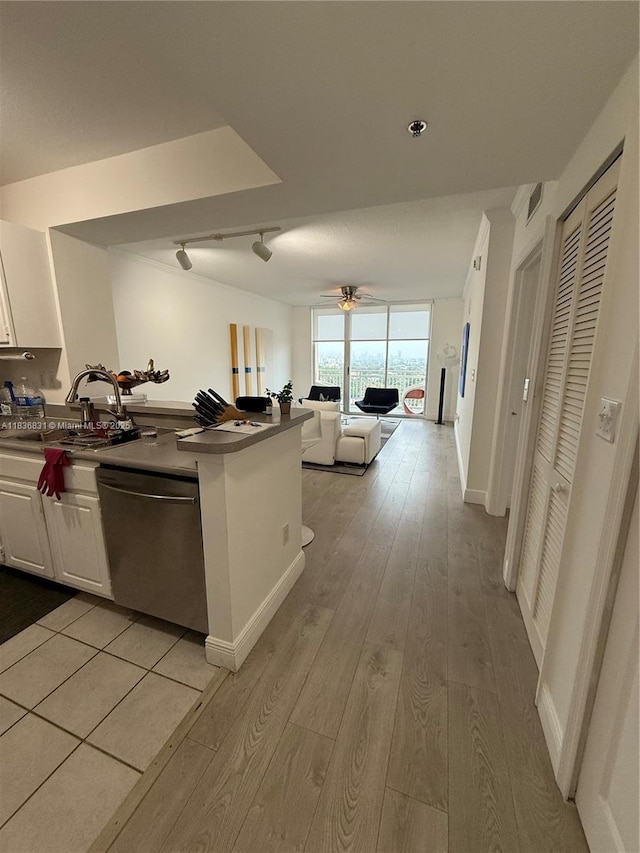 2665 SW 37th Ave Unit 1213, Miami, FL 33133 - kitchen featuring stainless steel dishwasher, open floor plan, light wood-type flooring, white cabinetry, and ceiling fan