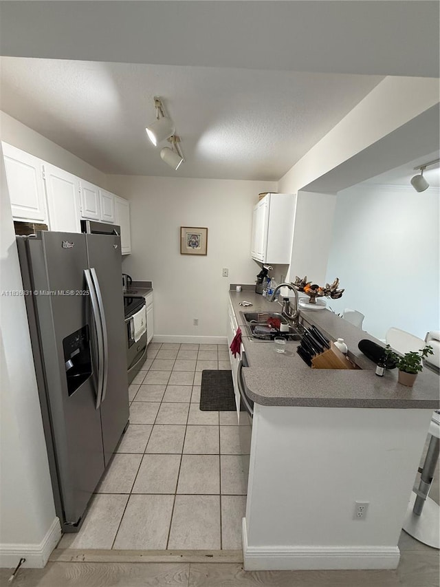 2665 SW 37th Ave Unit 1213, Miami, FL 33133 - kitchen with stainless steel fridge with ice dispenser, a peninsula, white cabinetry, electric range, and light tile patterned flooring
