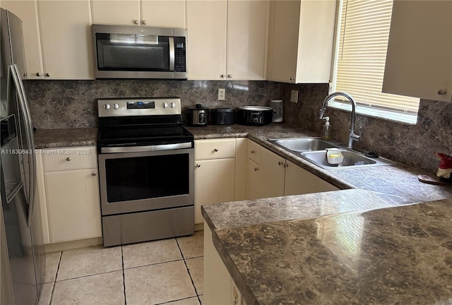 1549 SE 24th Ct Unit 225, Homestead, FL 33035 - kitchen with stainless steel appliances, light tile patterned floors, backsplash, and dark countertops