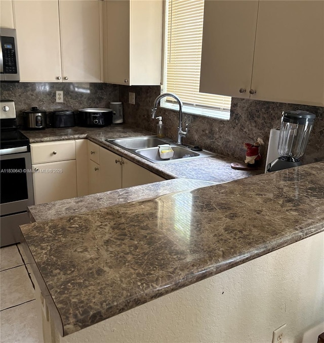 1549 SE 24th Ct Unit 225, Homestead, FL 33035 - kitchen featuring appliances with stainless steel finishes, decorative backsplash, dark countertops, and light tile patterned flooring