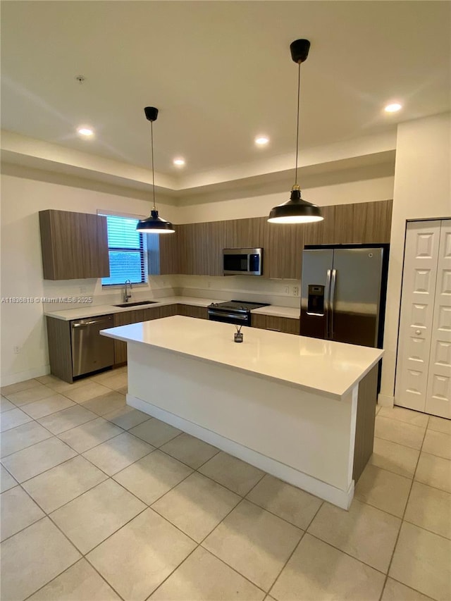 10455 NW 82nd St Unit 33, Doral, FL 33178 - kitchen with appliances with stainless steel finishes, modern cabinets, light countertops, a kitchen island, and recessed lighting