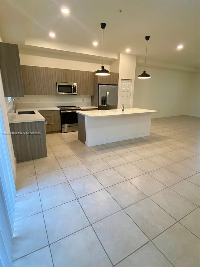 10455 NW 82nd St Unit 33, Doral, FL 33178 - kitchen with appliances with stainless steel finishes, modern cabinets, light countertops, light tile patterned floors, and a kitchen island