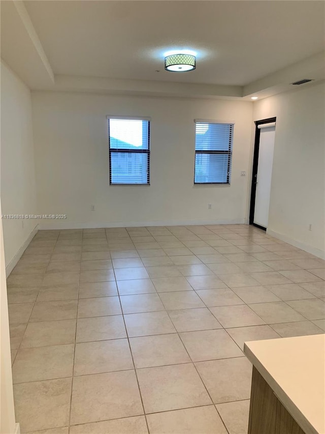 10455 NW 82nd St Unit 33, Doral, FL 33178 - empty room featuring light tile patterned flooring and a tray ceiling
