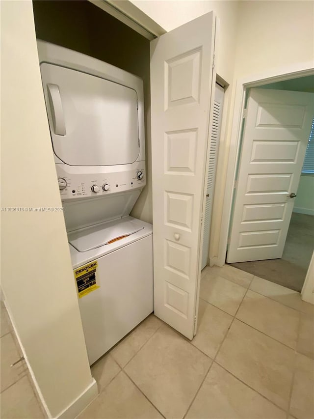 10455 NW 82nd St Unit 33, Doral, FL 33178 - laundry room featuring stacked washer / drying machine and light tile patterned floors