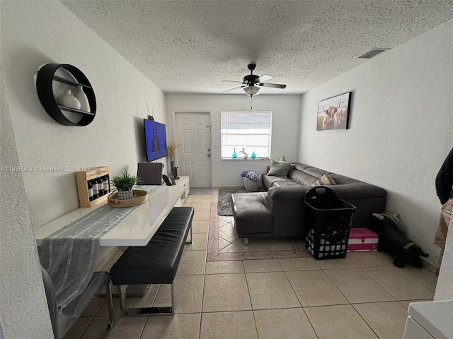 2651 NW 13th St Unit 45, Miami, FL 33125 - living room featuring a textured wall, a ceiling fan, a textured ceiling, and light tile patterned flooring