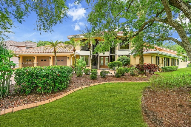 1910 Preston Trl, Coral Springs, FL 33071 - mediterranean / spanish home with stucco siding, french doors, a tiled roof, an attached garage, and a front yard