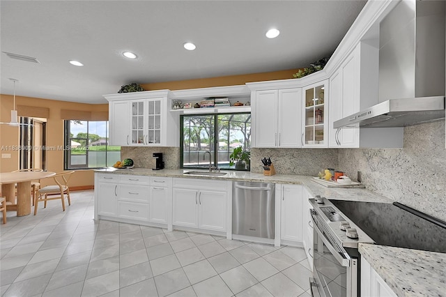 1910 Preston Trl, Coral Springs, FL 33071 - kitchen featuring wall chimney range hood, stainless steel appliances, recessed lighting, tasteful backsplash, and light tile patterned floors
