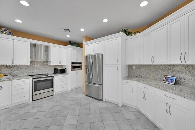 1910 Preston Trl, Coral Springs, FL 33071 - kitchen featuring stainless steel appliances, wall chimney exhaust hood, backsplash, white cabinetry, and recessed lighting